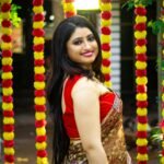 Elegant South Asian woman in traditional outfit with festive background in Kolkata.